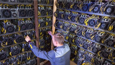 A large-scale mining farm with rows of ASICs, showcasing the scale of operations in cryptocurrency mining.