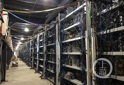 A large-scale cryptocurrency mining farm with rows of mining rigs