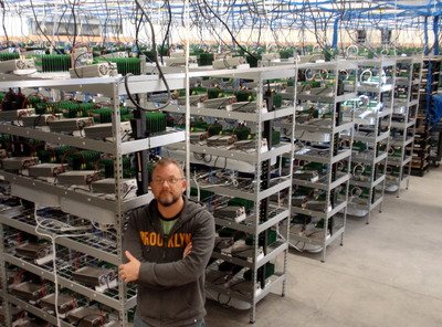 A Mining farm with rows of mining rigs, showcasing the scale and infrastructure involved in hosting mining machines.